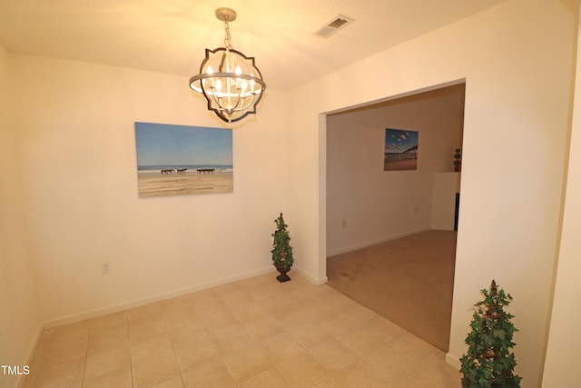 empty room with a notable chandelier