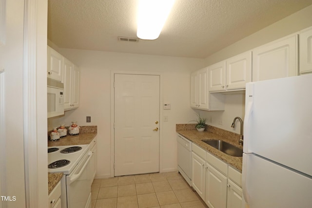 kitchen with white cabinets, white appliances, sink, and light tile patterned floors