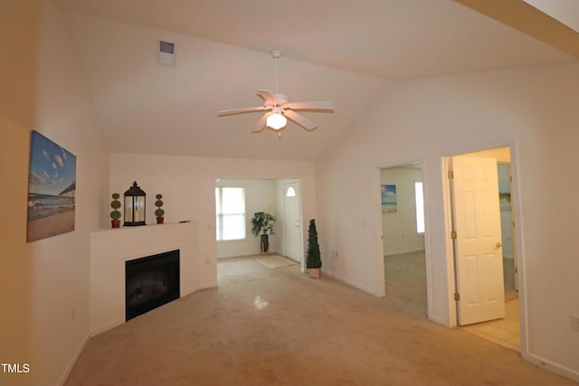 unfurnished living room featuring ceiling fan, lofted ceiling, and light carpet