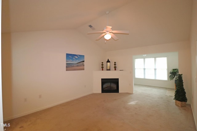 unfurnished living room featuring carpet flooring, ceiling fan, and vaulted ceiling