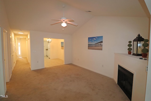 living room featuring ceiling fan, light carpet, and vaulted ceiling