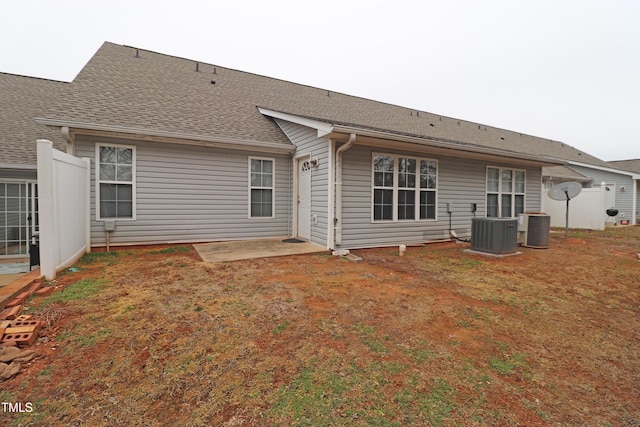 back of property with central air condition unit and a patio