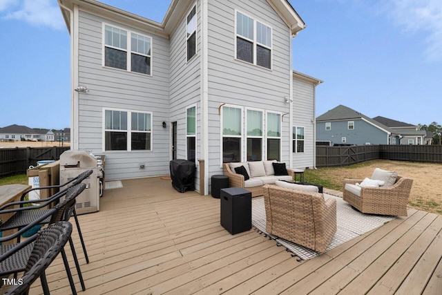 deck featuring outdoor lounge area and grilling area