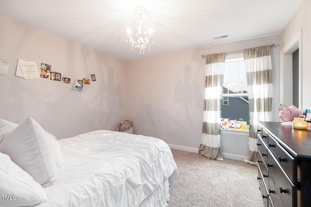 carpeted bedroom featuring an inviting chandelier