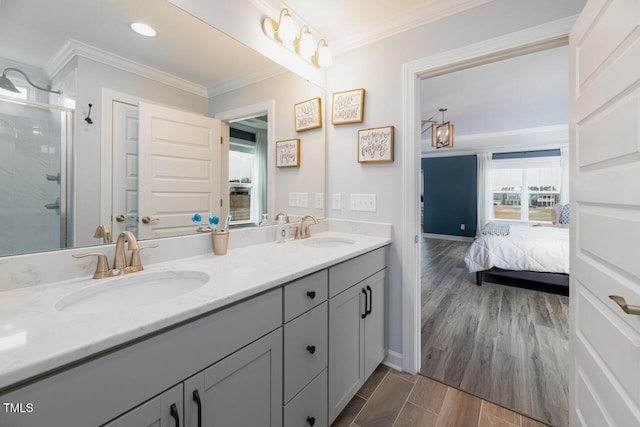 bathroom featuring ornamental molding, vanity, and a shower with shower door