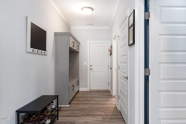 hall featuring crown molding and dark wood-type flooring