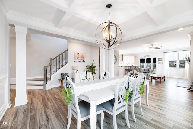 dining area with ornate columns, coffered ceiling, ceiling fan with notable chandelier, hardwood / wood-style flooring, and beamed ceiling