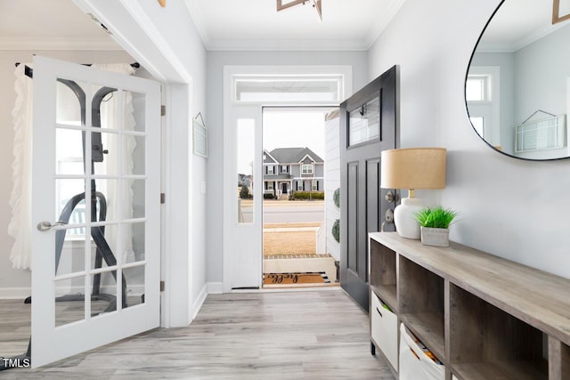 interior space with light wood-type flooring and crown molding