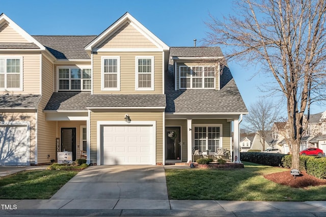 view of front facade featuring a front yard, a garage, and a porch