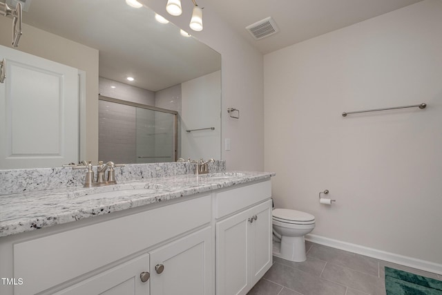 bathroom featuring a shower with shower door, tile patterned floors, toilet, and vanity