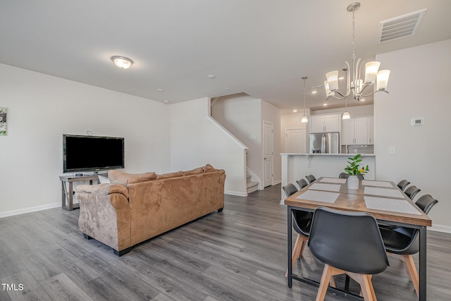 dining area with a chandelier and hardwood / wood-style flooring