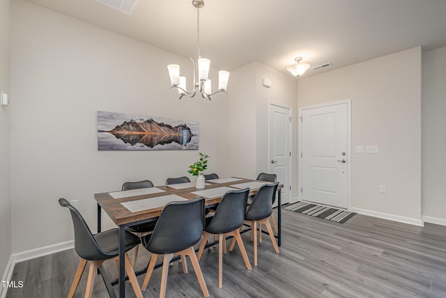 dining space featuring an inviting chandelier and hardwood / wood-style floors