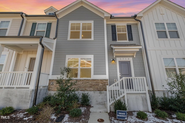 townhome / multi-family property featuring board and batten siding and stone siding