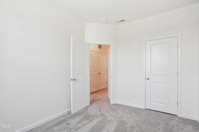 unfurnished bedroom with light colored carpet