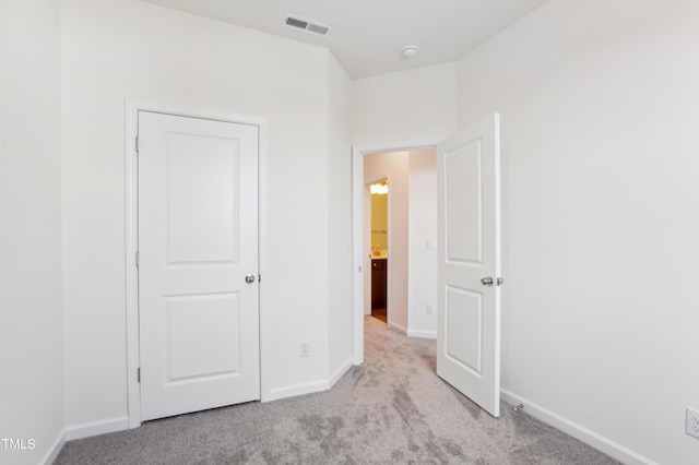 unfurnished bedroom with light colored carpet