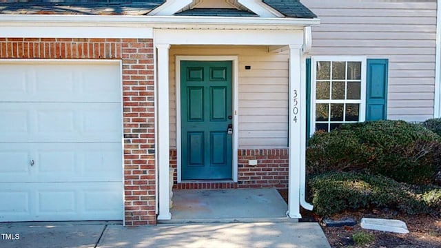 view of exterior entry with a garage