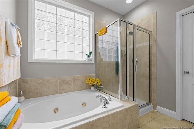 full bathroom with tile patterned floors, a stall shower, and a whirlpool tub