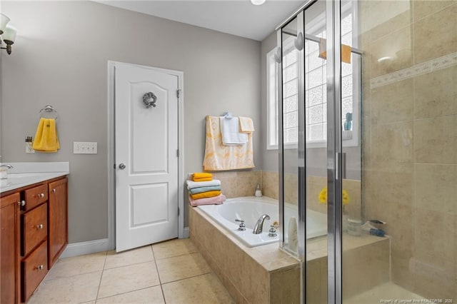 bathroom with tile patterned flooring, a garden tub, vanity, and a stall shower