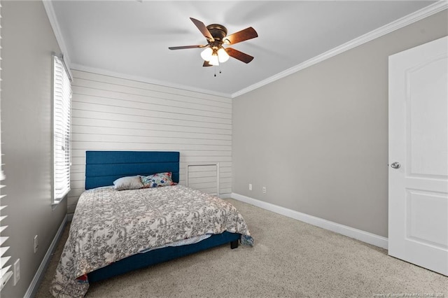 carpeted bedroom featuring ceiling fan, baseboards, and ornamental molding