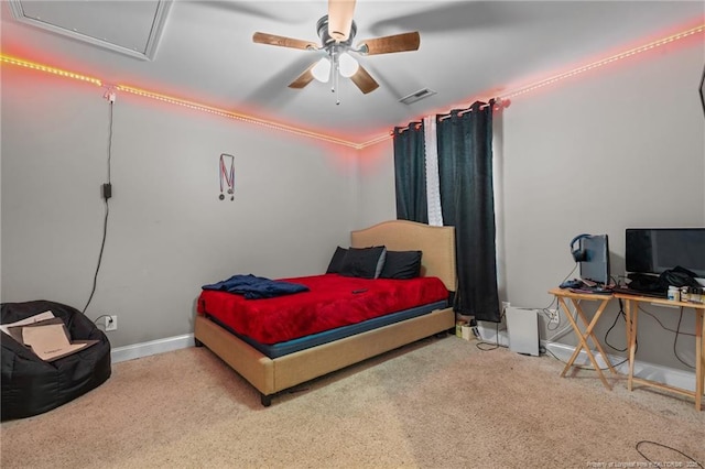 carpeted bedroom with visible vents, baseboards, and a ceiling fan