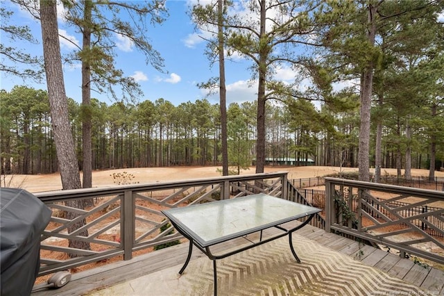 wooden deck with a grill