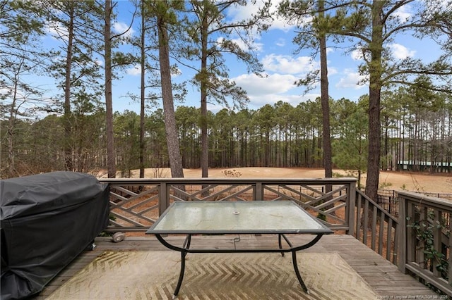 deck featuring a grill and a forest view