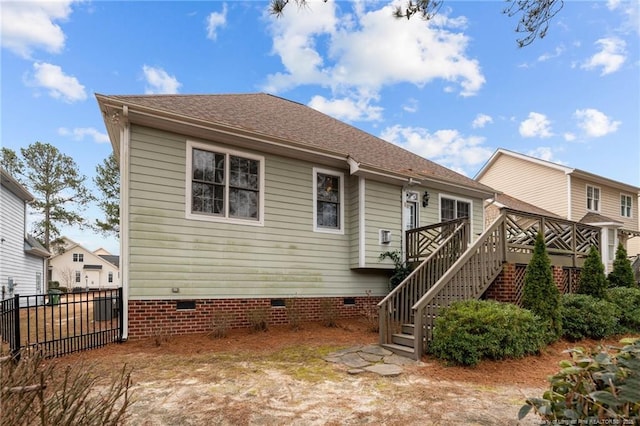 back of property featuring stairs, fence, a shingled roof, and crawl space