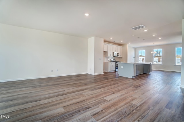 851 Parc Townes Dr Unit 10, Wendell, NC 27591 - unfurnished living room with dark hardwood / wood-style flooring, sink, and a chandelier