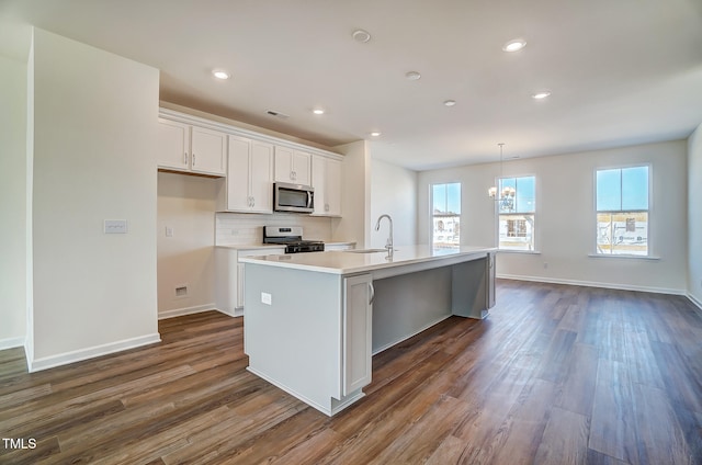851 Parc Townes Dr Unit 10, Wendell, NC 27591 - kitchen with appliances with stainless steel finishes, white cabinetry, an island with sink, sink, and dark wood-type flooring