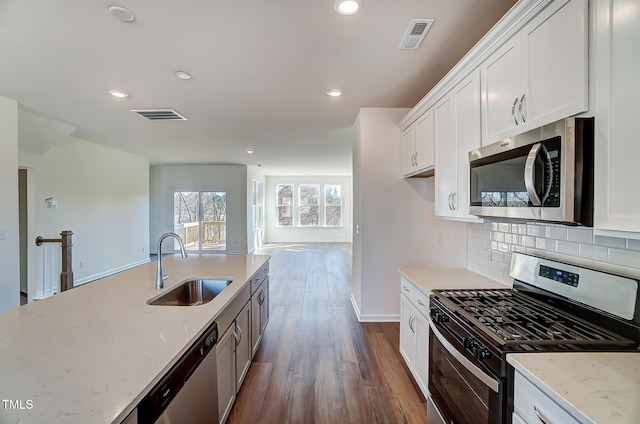 851 Parc Townes Dr Unit 10, Wendell, NC 27591 - kitchen with light stone counters, appliances with stainless steel finishes, sink, and white cabinets