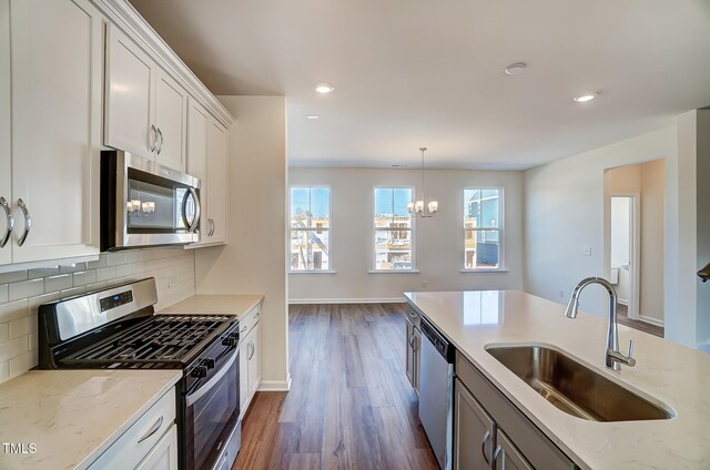 851 Parc Townes Dr Unit 10, Wendell, NC 27591 - kitchen featuring appliances with stainless steel finishes, light stone countertops, sink, and white cabinets