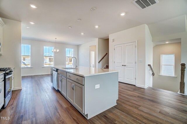 851 Parc Townes Dr Unit 10, Wendell, NC 27591 - kitchen featuring dark wood-type flooring, sink, hanging light fixtures, a center island with sink, and stainless steel appliances
