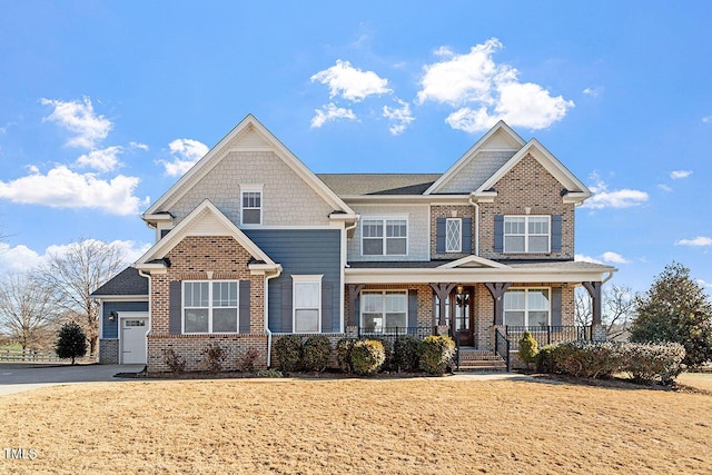 craftsman-style home with a front yard, covered porch, and a garage