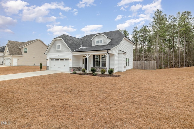 view of front facade with a porch, a garage, and a front lawn