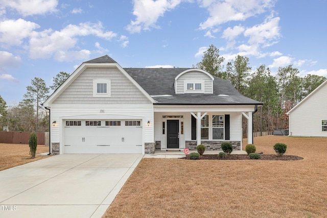 view of front facade with a front lawn, a porch, and a garage