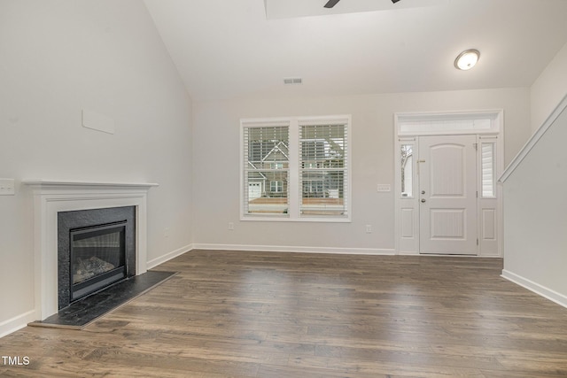 unfurnished living room with dark hardwood / wood-style floors, ceiling fan, and lofted ceiling