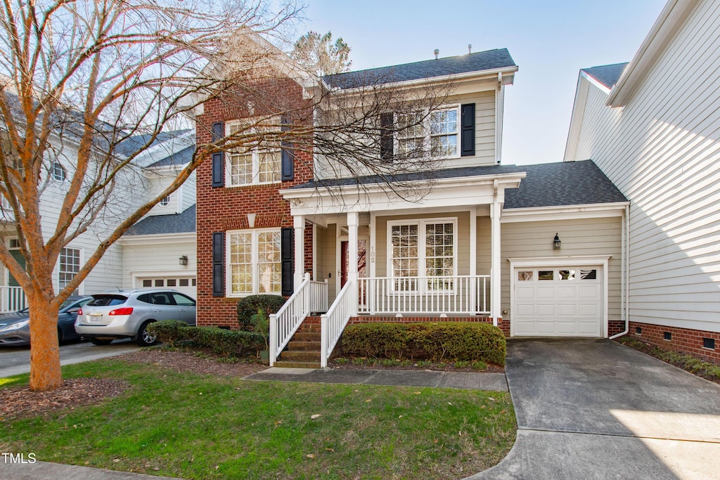 view of front of property featuring covered porch and a garage