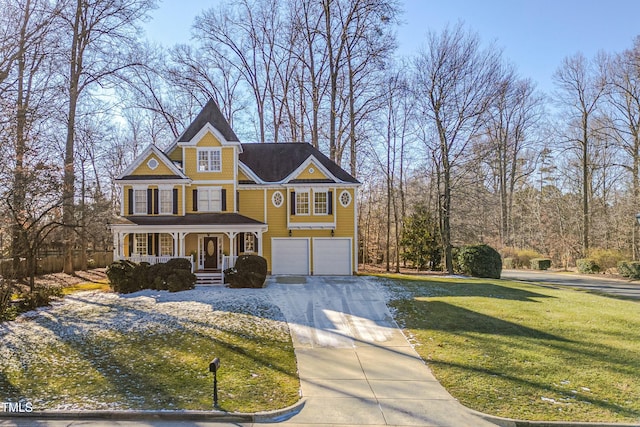 view of front facade with a porch, a front lawn, and a garage