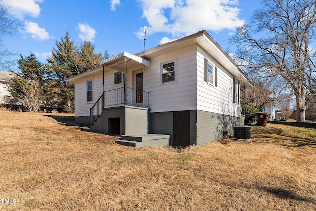 exterior space with a lawn and central AC unit