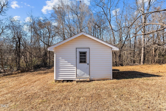 view of outbuilding with a yard