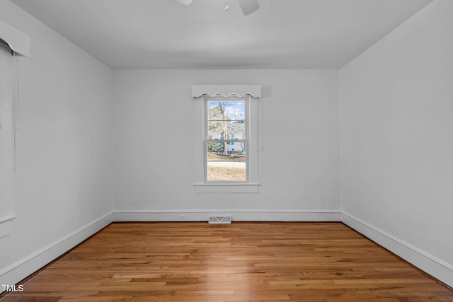 spare room with light hardwood / wood-style floors and ceiling fan