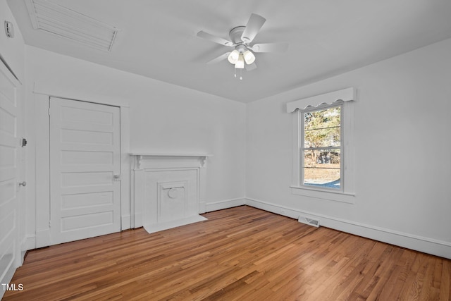 unfurnished room with ceiling fan and hardwood / wood-style flooring