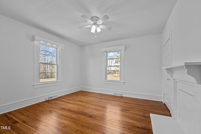 spare room featuring hardwood / wood-style flooring and ceiling fan