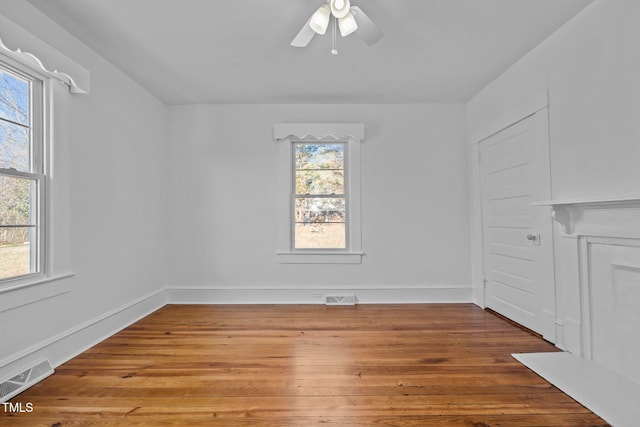 interior space featuring wood-type flooring, ceiling fan, and a healthy amount of sunlight