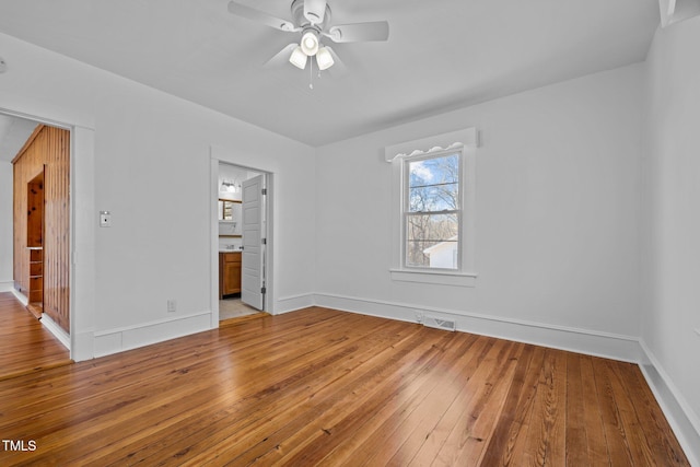 empty room with ceiling fan and hardwood / wood-style flooring