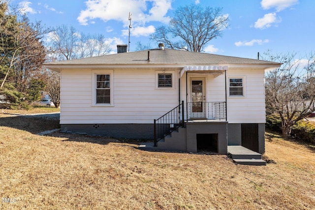 back of property with a lawn