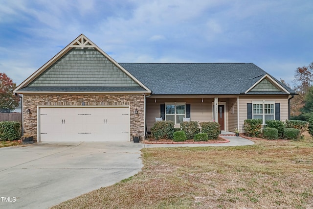 view of front of home featuring a front yard and a garage