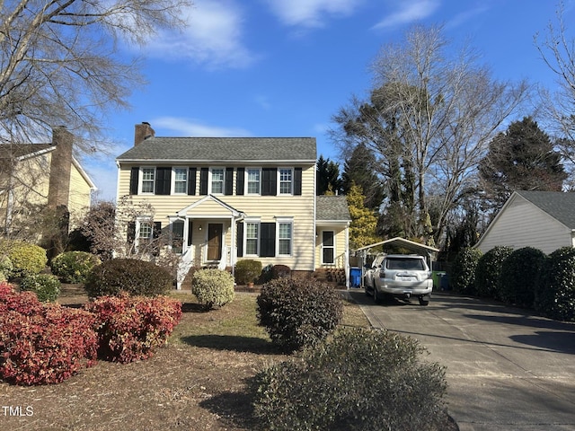 colonial inspired home with a carport