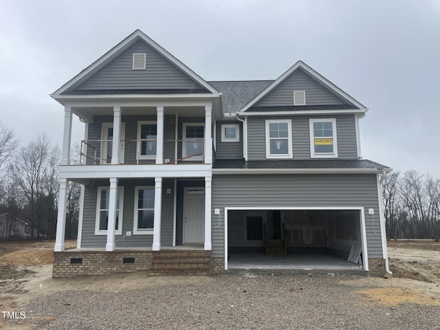 view of front of home with a balcony, a garage, and covered porch