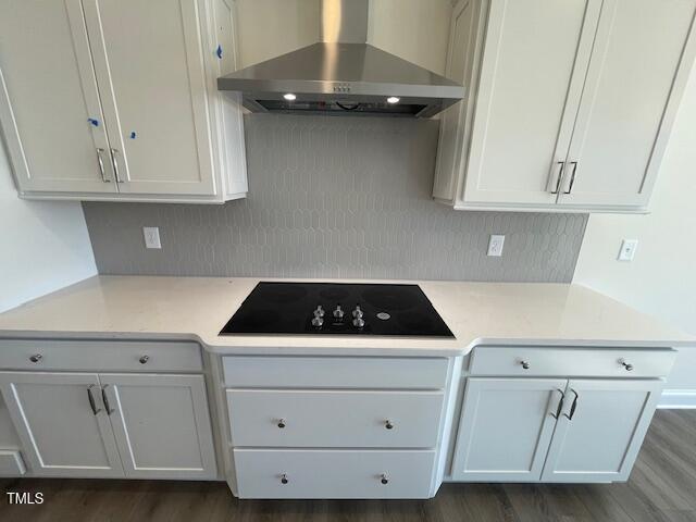 85 N Stagecoach Dr, Wendell, NC 27591 - kitchen with wall chimney exhaust hood, black electric cooktop, decorative backsplash, and light countertops